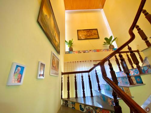 a staircase in a house with a wooden stair case at HeniSi Homestay Măng Đen Villa in Kon Von Kla