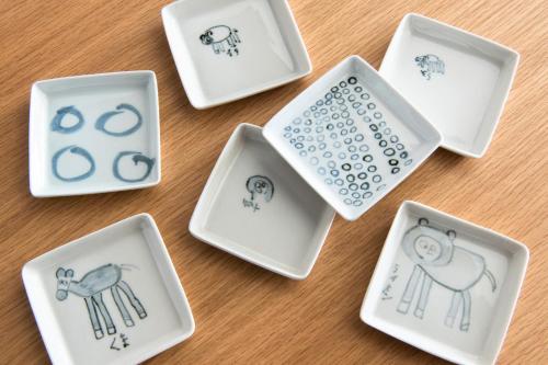 a group of white bowls on a table at Ace Hotel Kyoto in Kyoto