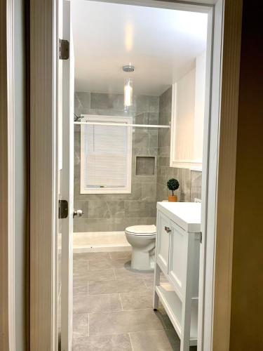 a bathroom with a toilet and a sink at Spacious 5BR 2Bath close to Niagara Falls and Casino in Niagara Falls