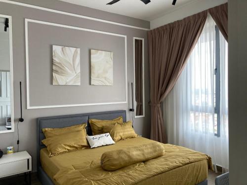 a bedroom with a large bed with yellow pillows at FREE NETFLIX! ZAs Suite at Troika Residence, KB in Kota Bharu