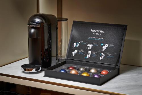 a box of balls on a counter next to a bottle of wine at L'Escape Hotel in Seoul