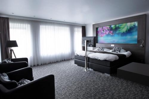 a bedroom with two beds and a large painting on the wall at Apart! Food & Drinks Apartments in Zwolle