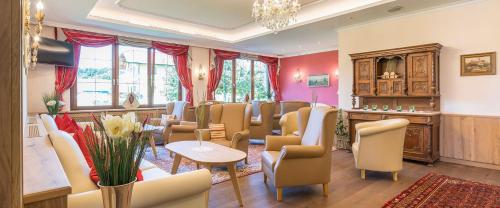 a salon with chairs and a waiting room at Vitalhotel Marienhof in Velden am Wörthersee