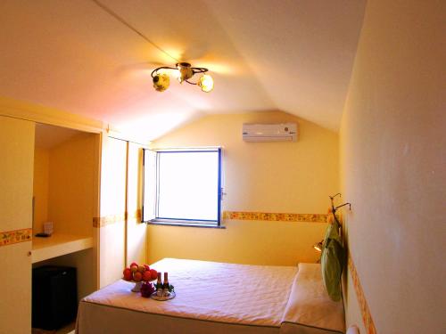 a bedroom with a bed in a room with a window at Locanda Degli Agrumi in Conca dei Marini