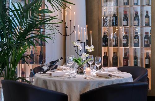 a table with a white table cloth and wine bottles at Terme Europa in Abano Terme
