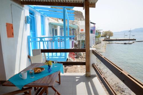 a table with a plate of food on a balcony at Nefeli's Sirma Klima in Klima