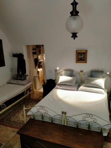 a bedroom with two beds and a table in it at Villa Longo de Bellis in Bari