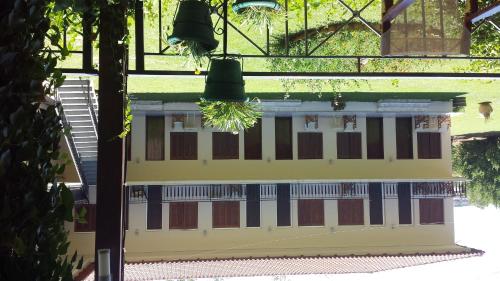 a building with two bells on top of it at Avaton Hotel in Ligourio