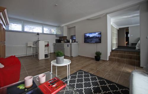 a living room with a red couch and a table at K House 5* Apartments in Kaufungen