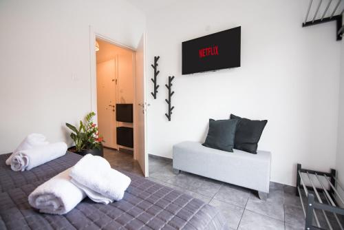 a living room with a couch and a clock on the wall at Lefkes Summer House #1 in Hanioti