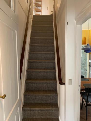 a staircase in a home with a stair case at Korinth Bed & Breakfast in Fåborg