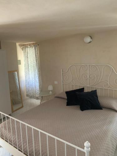 a bedroom with a large bed and a staircase at A pochi passi dal mare in Monterosso al Mare