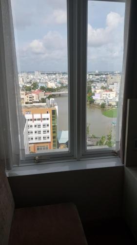 an open window with a view of a city at Holiday One Can Tho Hotel in Can Tho