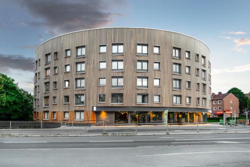 a large building on the side of a street at Sky Hotel Apartments Valla Berså in Linköping