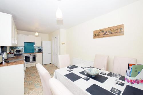 a kitchen and dining room with a table and chairs at Ardentorrie Holiday Home in Inverness