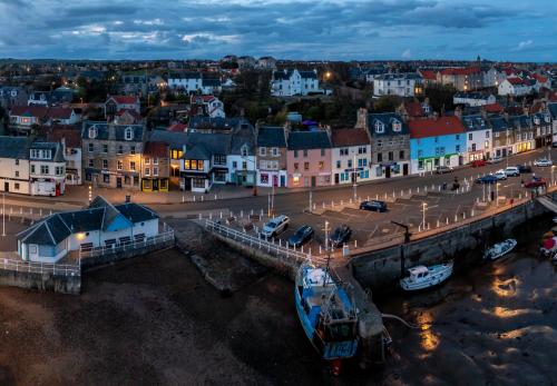 boats are docked in a harbor at The Waterfront in Anstruther