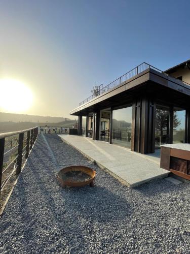 a building with a bowl on the ground next to a fence at Il GrecAle - Camere e Appartamenti in La Morra