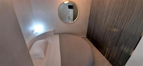 a small bathroom with a toilet and a mirror at Wrh Trastevere in Rome