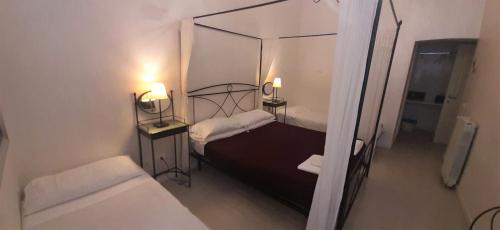 a small bedroom with a bed and a mirror at Wrh Trastevere in Rome