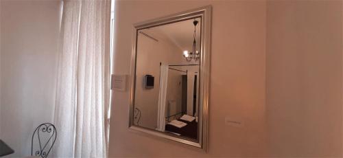 a mirror hanging on a wall in a bathroom at Wrh Trastevere in Rome