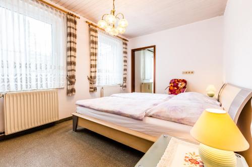 a bedroom with a bed and a table with a lamp at Ferienwohnung Köln-Altstadt-Nord in Cologne