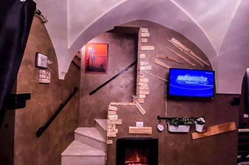 a room with a staircase with a clock on the wall at a Fasano la casa di Dony e Nicole in Fasano