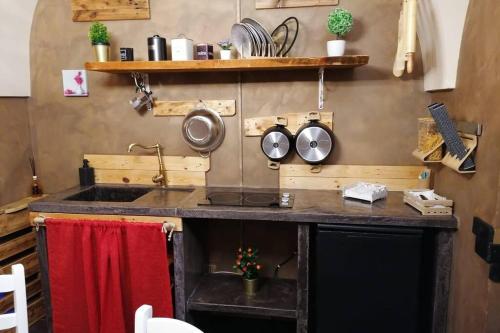 a kitchen with a sink and a counter with pots and pans at a Fasano la casa di Dony e Nicole in Fasano
