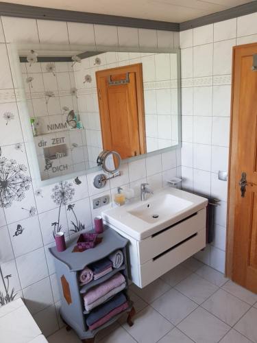 a bathroom with a sink and a mirror at Reithamer Bergfensterl in Warngau
