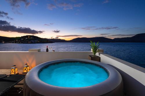 a hot tub on the deck of a cruise ship at Rementzo Apartment in Symi