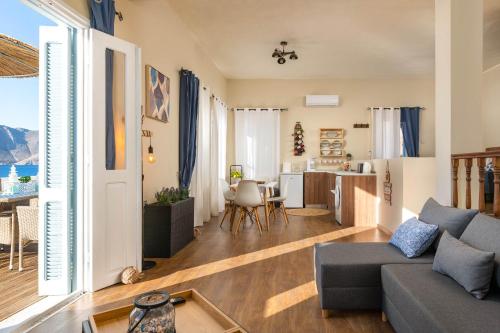 a living room with a couch and a kitchen at Rementzo Apartment in Symi