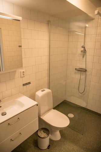 a bathroom with a toilet and a sink and a shower at Sky Hotel Apartments Valla Berså in Linköping