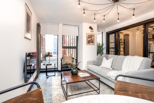 a living room with a couch and a table at The Brewers Rooms Contemporary Aparthotel in Edinburgh