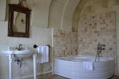 a bathroom with a tub and a sink at Cappa Villa Cave Hotel & Spa in Ürgüp