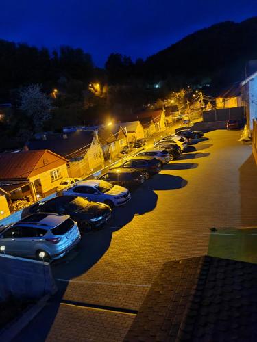 a row of cars parked in a parking lot at night at Casa Piri in Anina