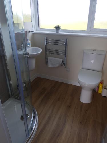 a bathroom with a toilet and a sink at Lindisfarne Self Catering in Navershaw