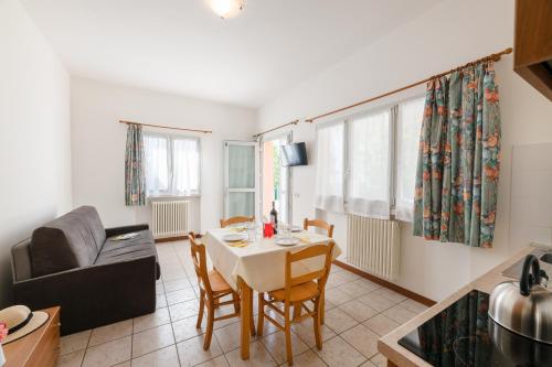 a living room with a table and a couch at Le Palme Camping & Village in Lazise