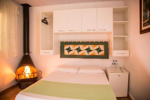 En eller flere senger på et rom på Pousada Canto Verde