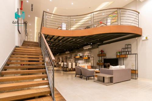 a spiral staircase in a store with a lobby at Terrace View Serviced Apartments 3 in Dammam