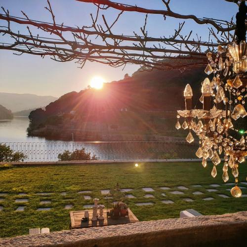 a chandelier with the sunset in the background at Douro Suites in Riba Douro