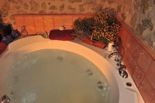 a bath tub in a bathroom with aperature at Las Moradas Del Temple in Mirambel