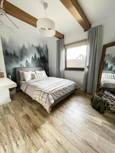 a bedroom with a bed and a large window at Kurs Siemiany, dom z jacuzzi i sauną na wyłączność in Siemiany