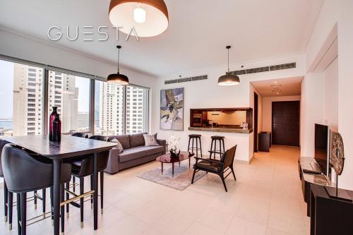 a living room with a couch and a table at Marina Promenade - Paloma Tower, Dubai Marina in Dubai