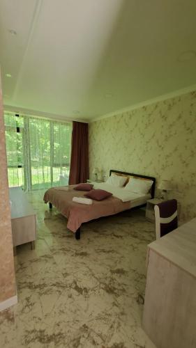 a bedroom with a large bed in a room at Kvareli Oaks in Kvareli