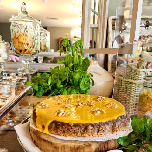 a cake sitting on a plate on a table at Douro Suites in Riba Douro