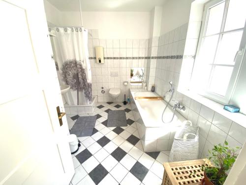 ein weißes Bad mit einer Badewanne und einem WC in der Unterkunft Ferienwohnung Brötzingen - EG in Pforzheim