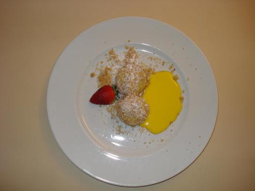 a white plate with a dessert with a strawberry and mustard at Sporthotel Rasen in Rasùn di Sotto
