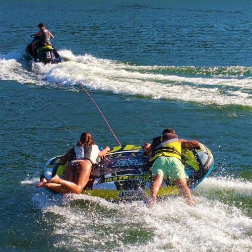 two people on a jet ski in the water at Douro Suites in Riba Douro