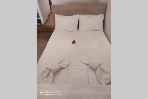 a white bed with a pair of shoes on it at Lefkas Central in Lefkada