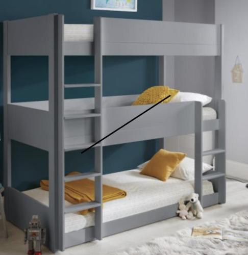 a gray bunk bed in a room with at Burrator Inn in Yelverton