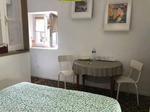 a room with a table and chairs and a bed at LE BOURGUET in Solliès-Pont